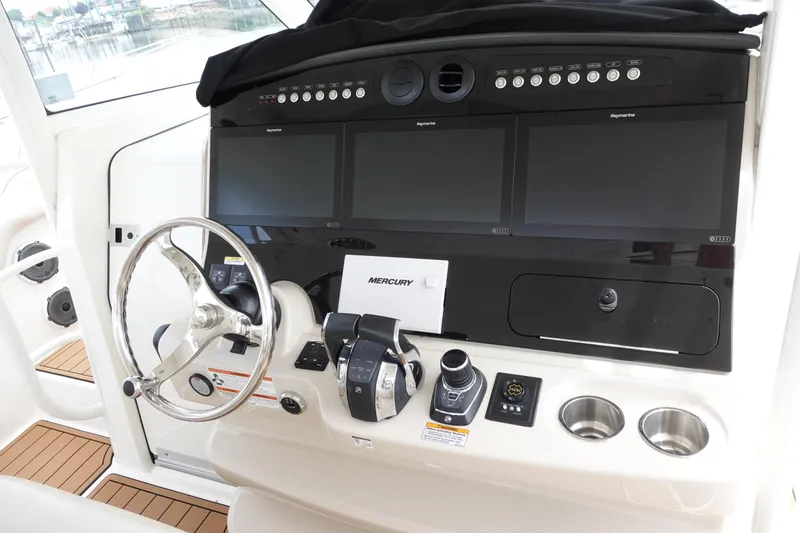Slide: The Image of Control panel of a 2020 Boston Whaler 420 Outrage with advanced navigation displays. - 12