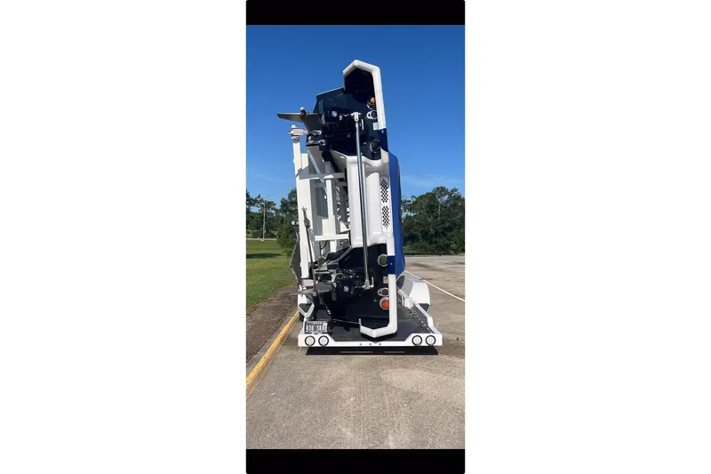 Slide: The Image of 2020 Skater 438 model boat on trailer, parked outdoors under clear blue sky. - 38