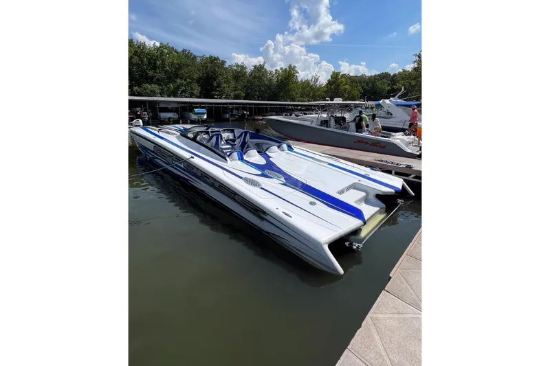 Slide: The Image of 2020 Skater 438 powerboat docked on a sunny day, featuring sleek blue and white design. - 37