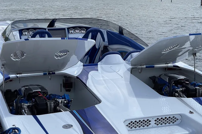 Slide: The Image of High-performance Skater 438 boat, 2020 model, with open engine compartments on the water. - 13