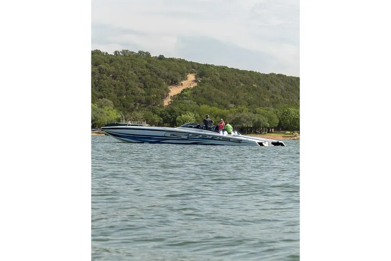 Slide: The Image of 2020 Skater 438 boat cruising on a lake with forested hills in the background. - 34