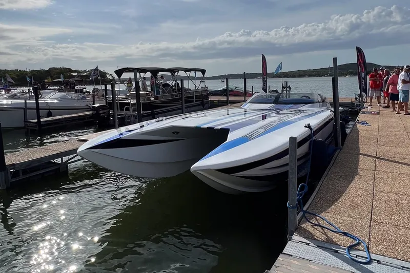 Slide: The Image of A 2020 Skater 438 powerboat docked at a marina under a partly cloudy sky. - 4