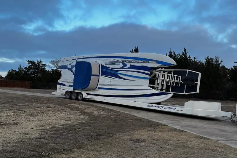 Slide: The Image of 2020 Skater 438 boat on trailer, parked outdoors under cloudy sky. - 32