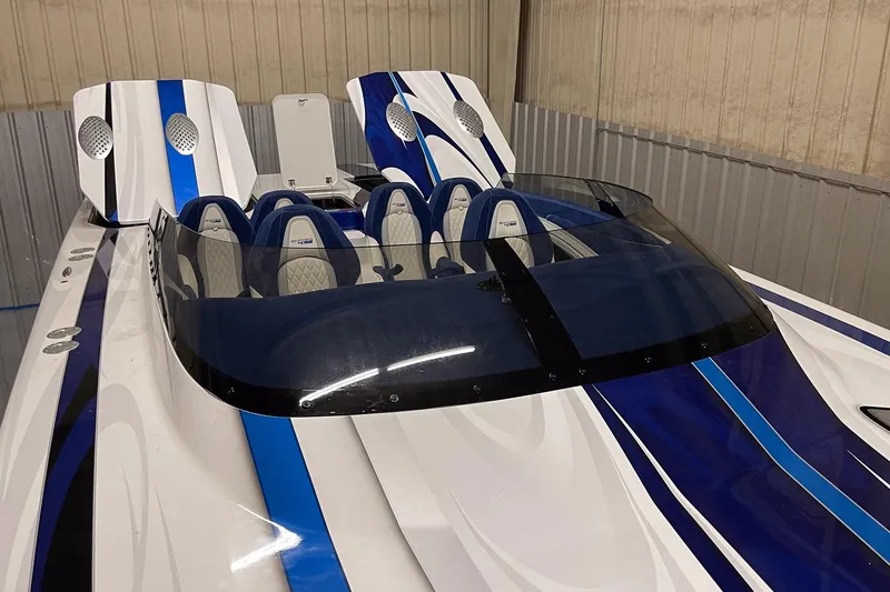 Slide: The Image of 2020 Skater 438 speedboat with blue and white design in a storage facility. - 8