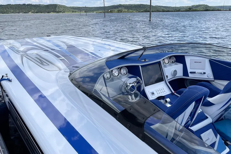 Slide: The Image of Luxury Skater 438 speedboat cockpit with sleek design, blue accents, and advanced controls on water. - 17