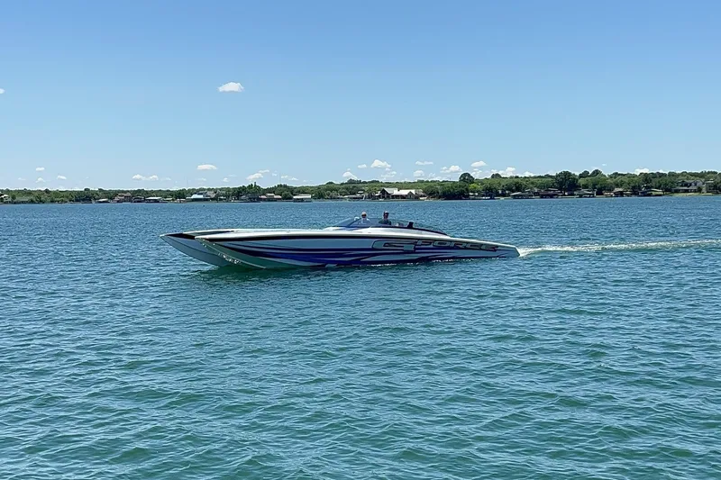 Slide: The Image of High-performance Skater 438 speedboat cruising on a lake under clear blue skies. - 28