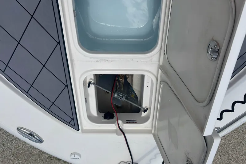 Slide: The Image of Open storage compartment on 2022 Robalo 266 Cayman boat, showing interior details. - 20