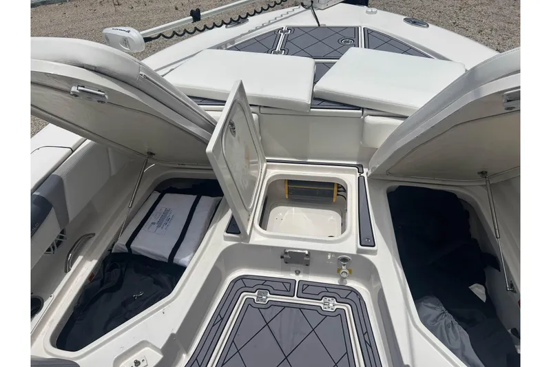 Slide: The Image of 2022 Robalo 266 Cayman boat storage compartments open, showcasing spacious interior design. - 19