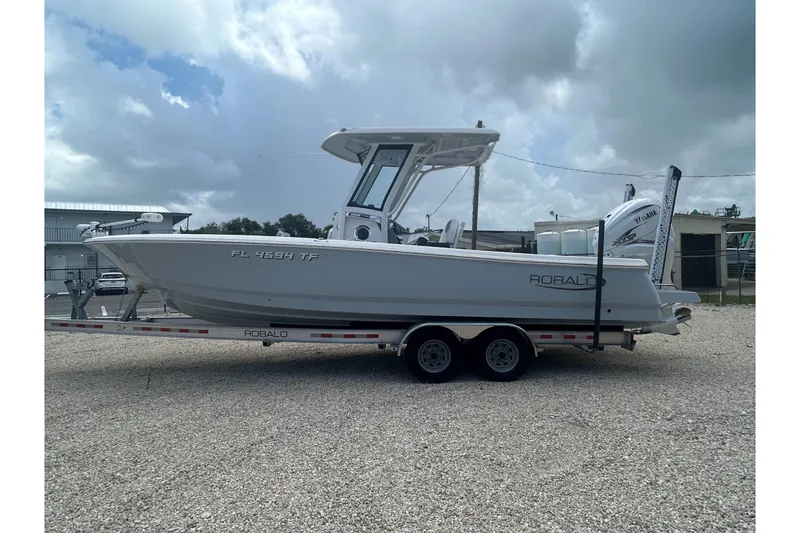 Slide: The Image of 2022 Robalo 266 Cayman boat on trailer, side view under cloudy sky. - 3