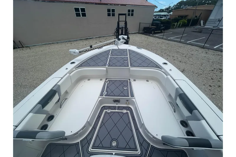 Slide: The Image of 2022 Robalo 266 Cayman boat deck with cushioned seating and storage compartments. - 14