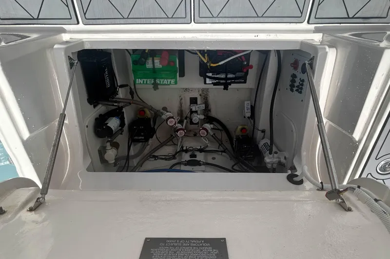 Slide: The Image of 2022 Robalo 266 Cayman boat electrical compartment with battery and wiring. - 11