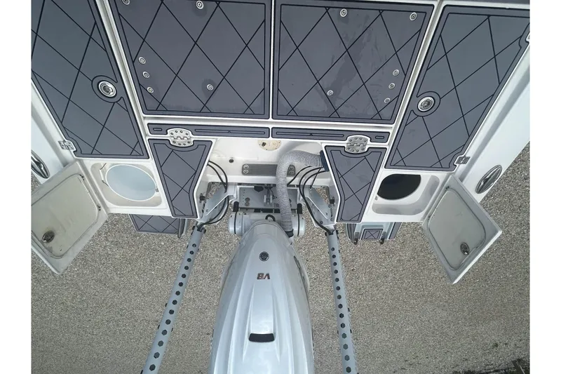 Slide: The Image of 2022 Robalo 266 Cayman boat deck with storage compartments and motor. - 12