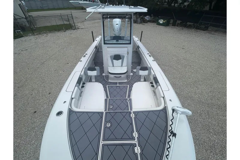 Slide: The Image of 2022 Robalo 266 Cayman boat interior with sleek design and spacious deck layout. - 13