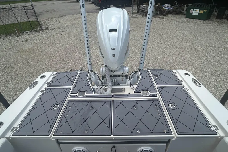 Slide: The Image of 2022 Robalo 266 Cayman boat deck with V8 engine and storage compartments. - 8