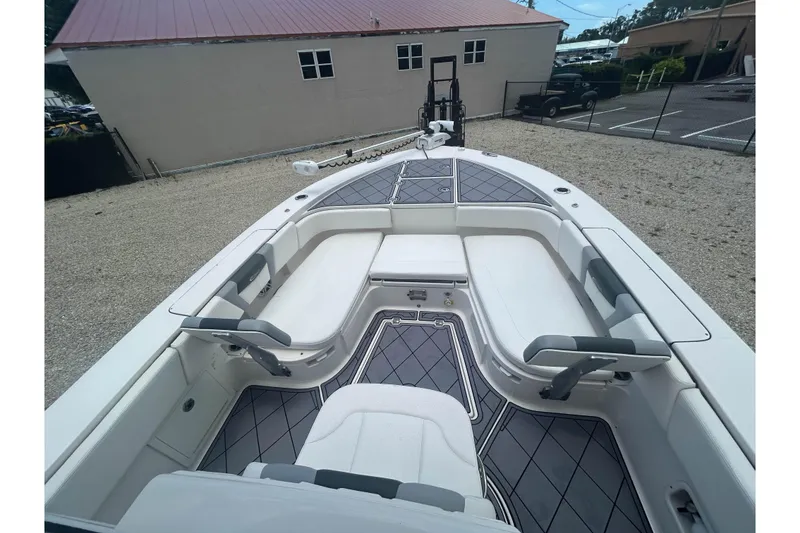 Slide: The Image of 2022 Robalo 266 Cayman boat interior with cushioned seating and non-slip flooring. - 15