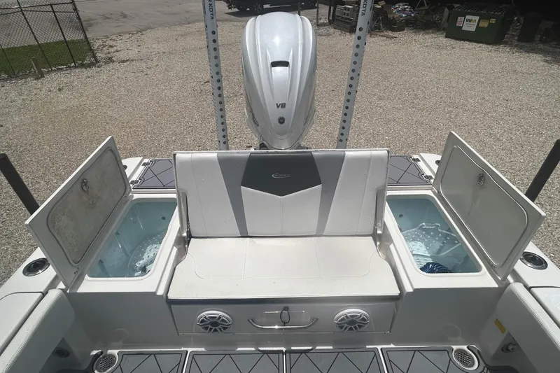 Slide: The Image of 2022 Robalo 266 Cayman boat interior with open storage compartments and seating. - 10