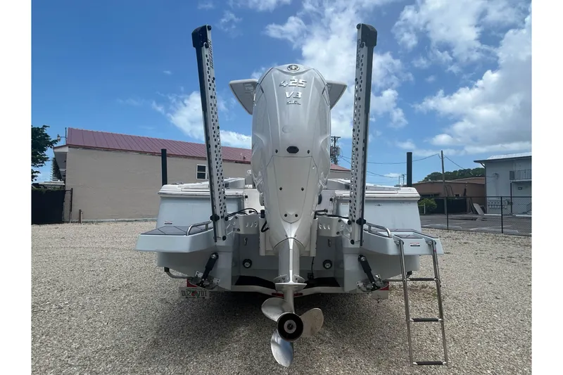 Slide: The Image of 2022 Robalo 266 Cayman boat with powerful 425 V8 engine, parked outdoors. - 2
