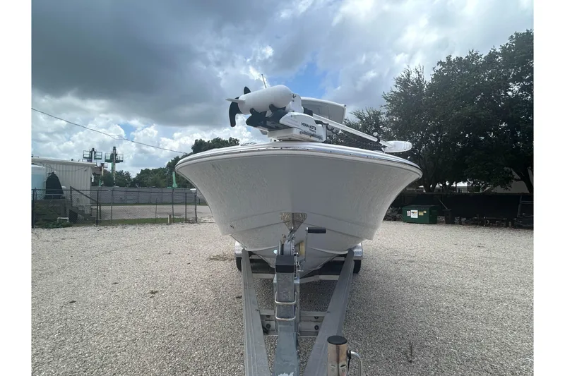 Slide: The Image of 2022 Robalo 266 Cayman boat on trailer under cloudy sky. - 4