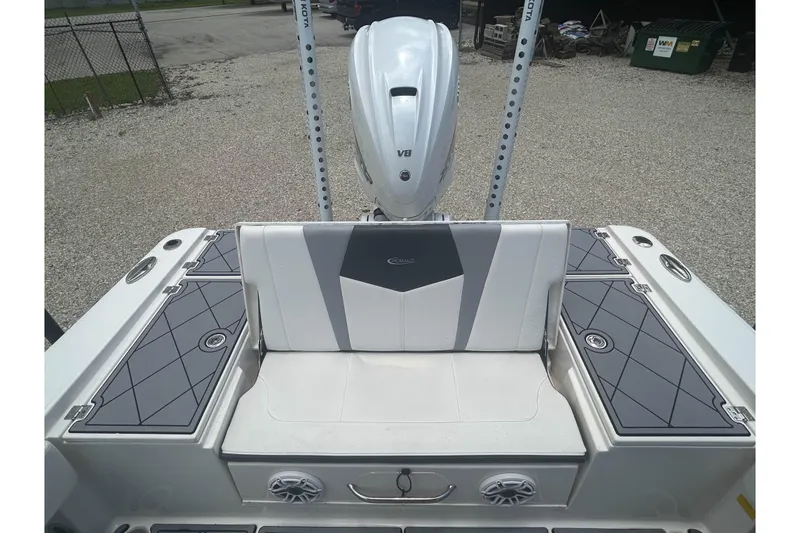 Slide: The Image of 2022 Robalo 266 Cayman boat interior with cushioned seating and V8 engine. - 9