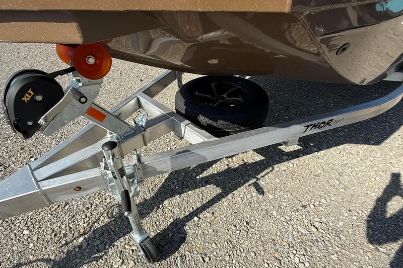 Slide: The Image of Trailer hitch of 2027 Thor LH1900SC boat on gravel surface, featuring XLT winch. - 9