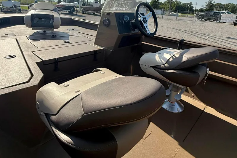 Slide: The Image of 2027 Thor LH1900SC boat interior with modern seating and steering wheel, parked outdoors. - 5