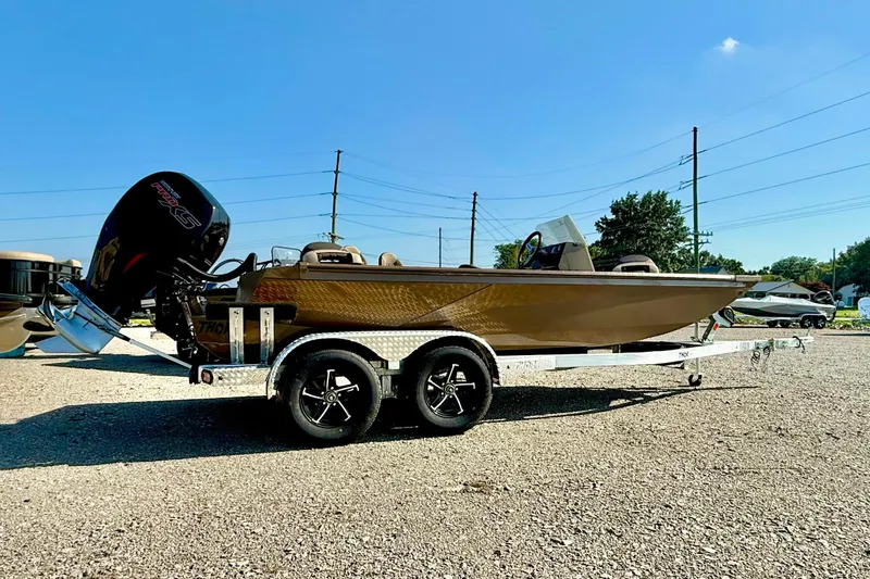The Image of 2027 Thor LH1900SC boat on trailer, parked outdoors under clear blue sky. - 1