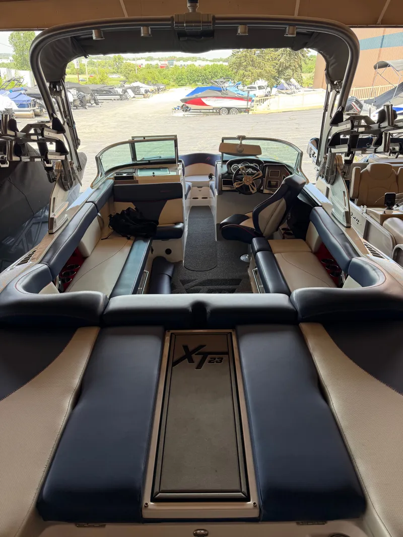 Slide: The Image of The image shows the interior of a 2018 MasterCraft XT23 with luxurious seating and a modern helm. - 2
