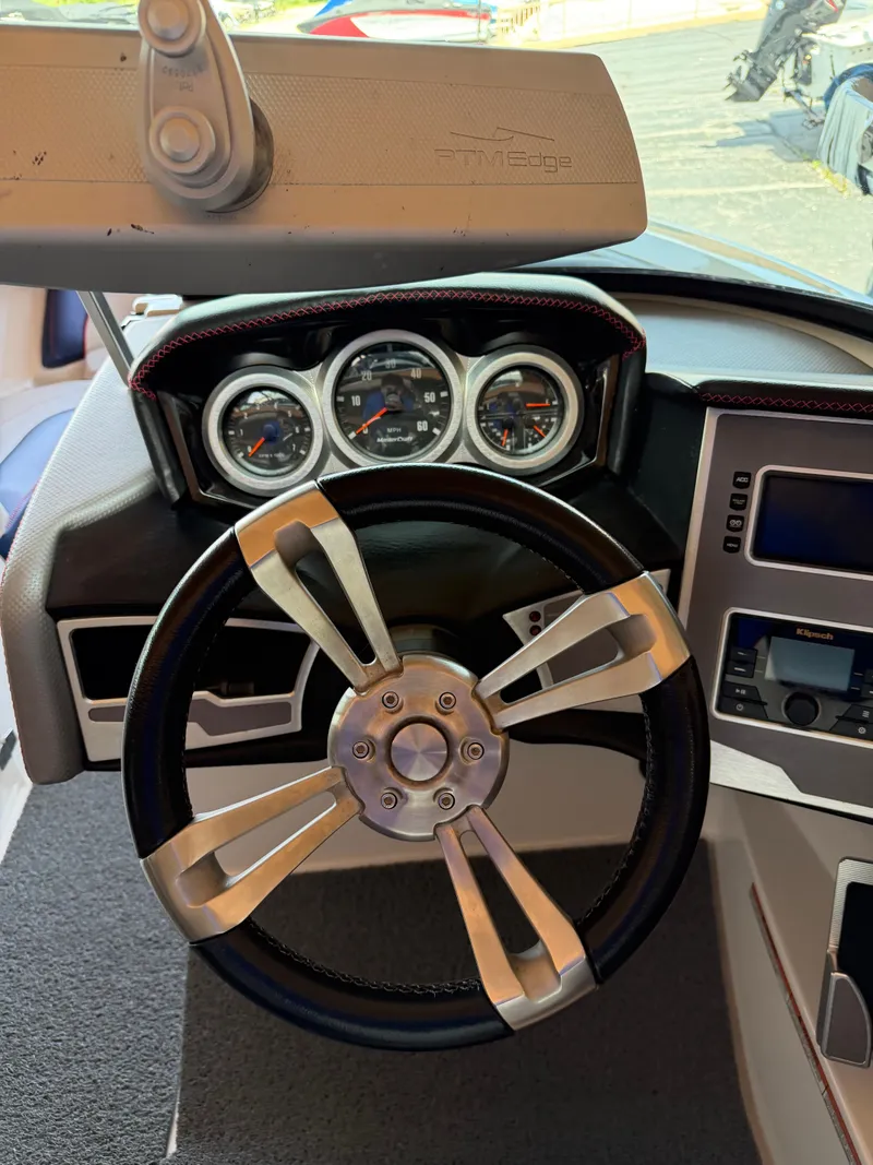 Slide: The Image of The image shows the helm of a 2018 MasterCraft XT23 with modern gauges. - 8