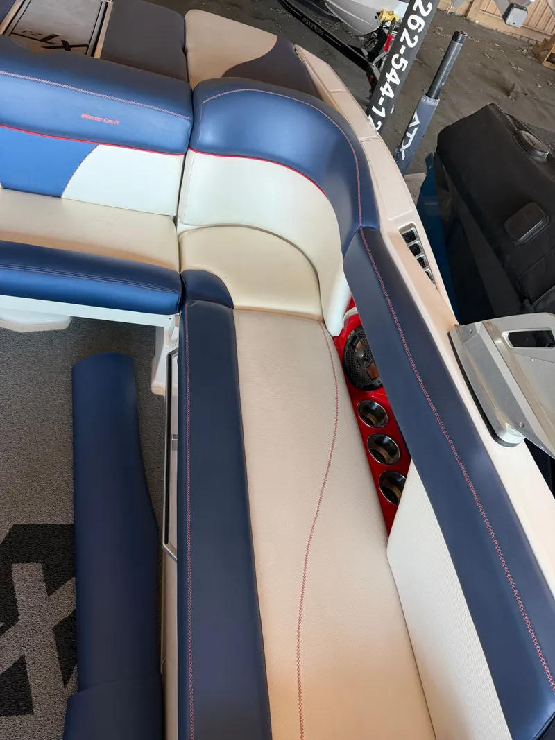 Slide: The Image of Interior of a 2018 MasterCraft XT23 with blue and white upholstery and red accents. - 4