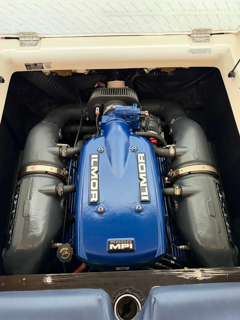 Slide: The Image of The engine compartment of a 2018 MasterCraft XT23 features a blue Ilmor 6000 MPI engine. - 16