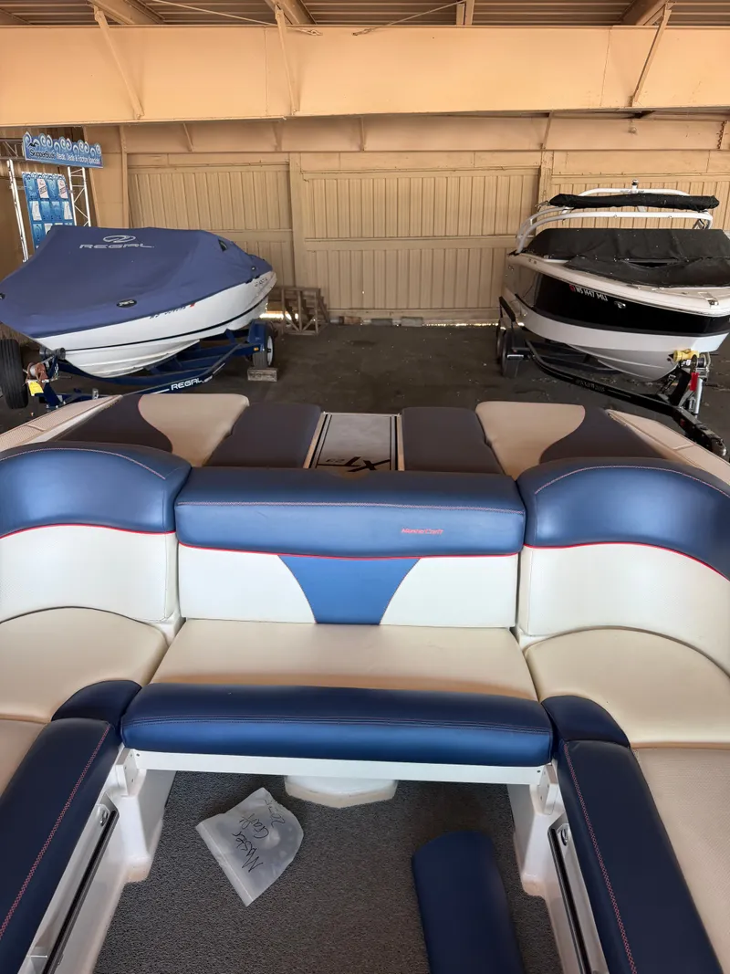 Slide: The Image of Interior of a 2018 MasterCraft XT23 with blue and white seating. - 5