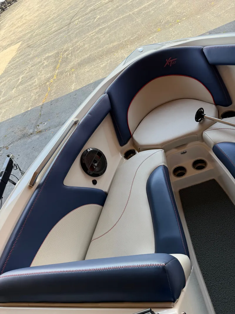 Slide: The Image of The image shows the interior of a 2018 MasterCraft XT23 boat with blue and white seating. - 11