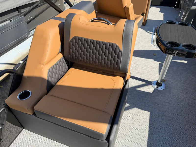 Slide: The Image of The 2027 Sylvan X1 LZ DH features brown and black leather seating with a small table. - 23