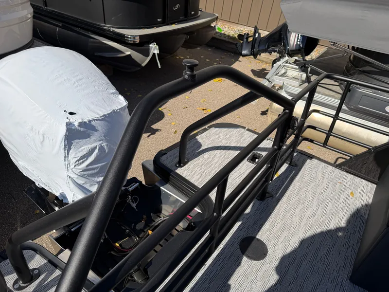 Slide: The Image of The image shows the rear of a 2027 Sylvan X1 LZ DH boat with a covered engine. - 25