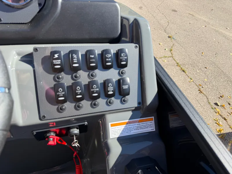 Slide: The Image of Close-up of a boat control panel with multiple switches and an ignition key. - 18