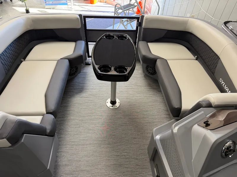 Slide: The Image of Interior of a 2027 Sylvan R-22 CLZ DH with gray and black seating and a table. - 3