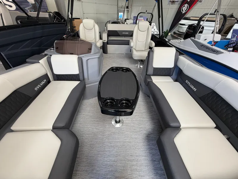 Slide: The Image of Interior of a 2027 Sylvan R-22 CLZ DH with gray and white seating and a table. - 4