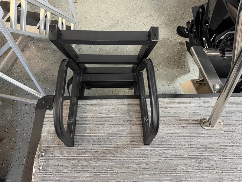 Slide: The Image of A black ladder is attached to a gray deck of a boat. - 29