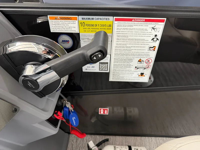 Slide: The Image of Close-up of the control area on a Sylvan R-22 CLZ DH boat with warning labels. - 19