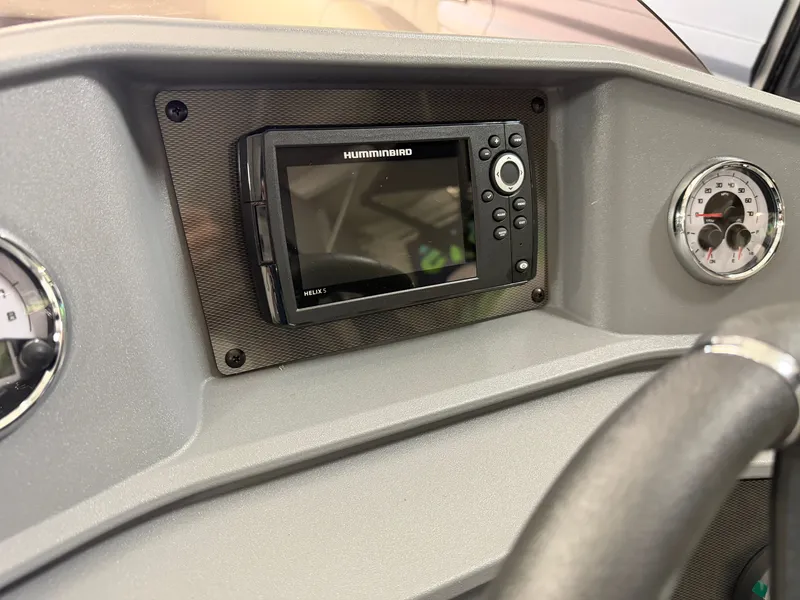 Slide: The Image of The image shows the dashboard of a Sylvan R-22 CLZ DH boat with a Humminbird fish finder. - 17