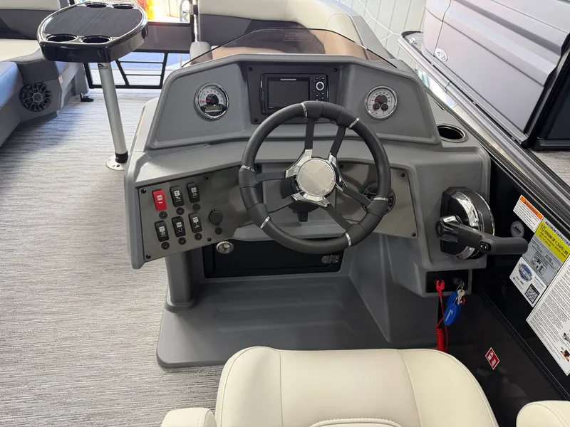 Slide: The Image of The image shows the helm of a 2027 Sylvan R-22 CLZ DH boat with modern controls. - 14