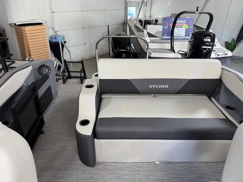 Slide: The Image of The image shows the interior of a Sylvan R-22 CLZ DH boat with gray and black seating. - 20