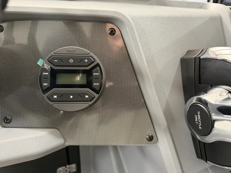 Slide: The Image of Close-up of the helm console on a Sylvan R-22 CLZ DH boat with controls. - 18
