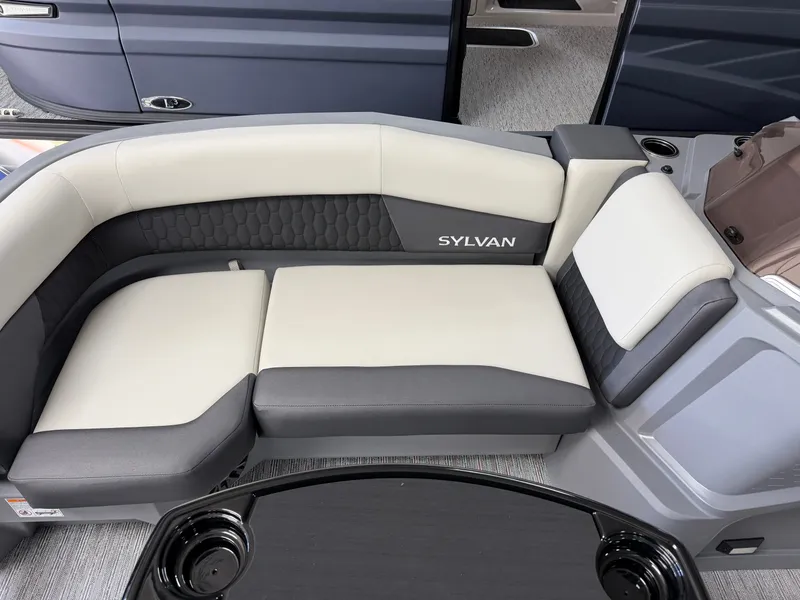 Slide: The Image of The image shows the seating area of a Sylvan R-22 CLZ DH boat with gray and white upholstery. - 6