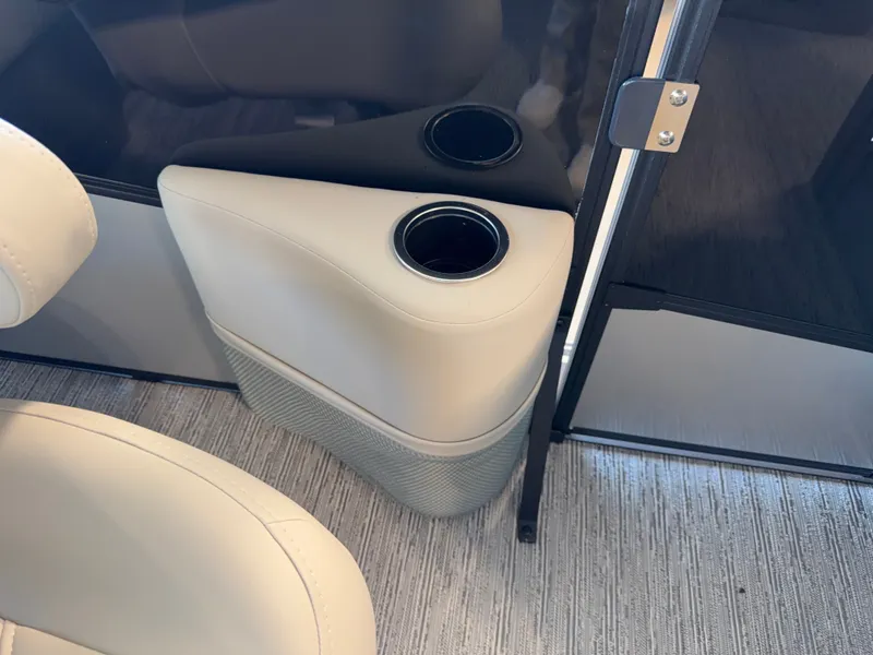 Slide: The Image of A sleek cup holder in a modern boat with beige upholstery and carpeted flooring. - 21
