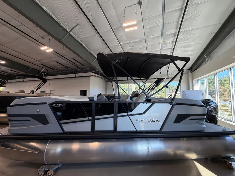 The Image of The image shows a 2027 Sylvan R-20 LZ DH pontoon boat in a showroom. - 0
