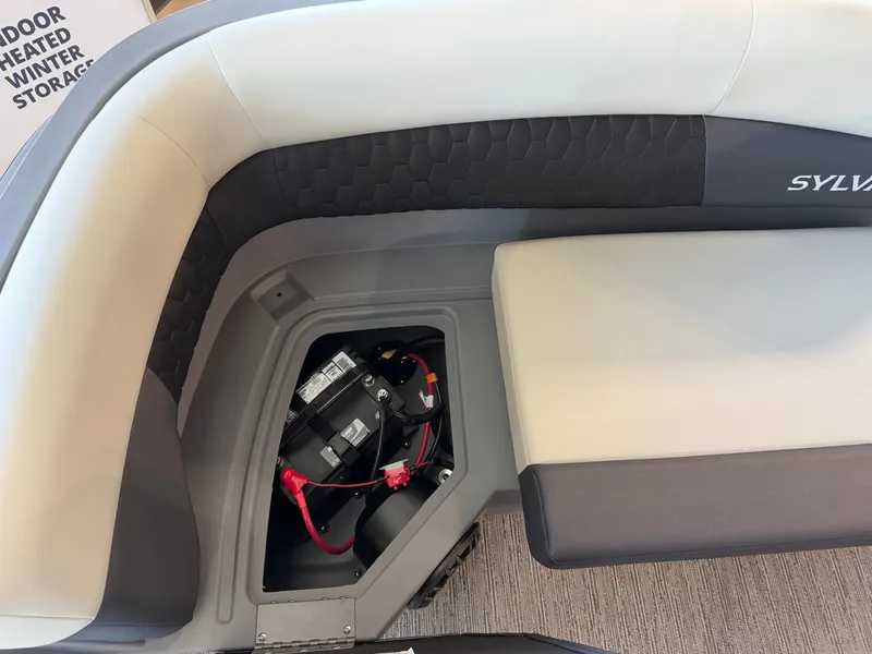 Slide: The Image of The image shows the seating area of a Sylvan R-20 LZ DH boat with a battery compartment. - 24