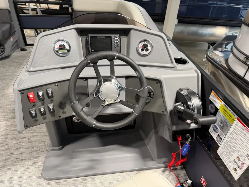 Slide: The Image of The image shows the helm of a Sylvan R-22 LZ DH boat with modern instruments. - 11