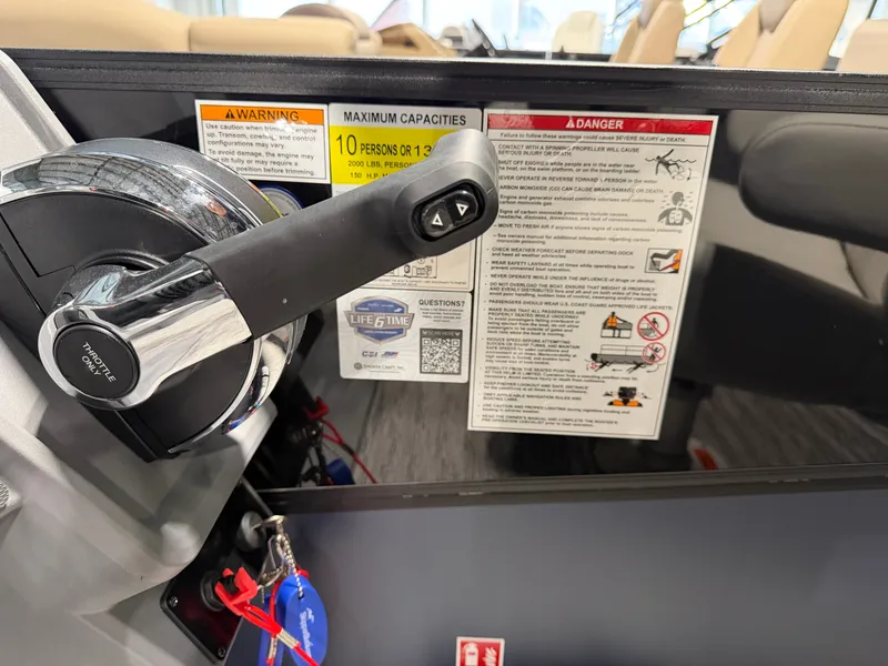 Slide: The Image of Close-up of the control console on a Sylvan R-22 LZ DH boat with warning labels. - 18