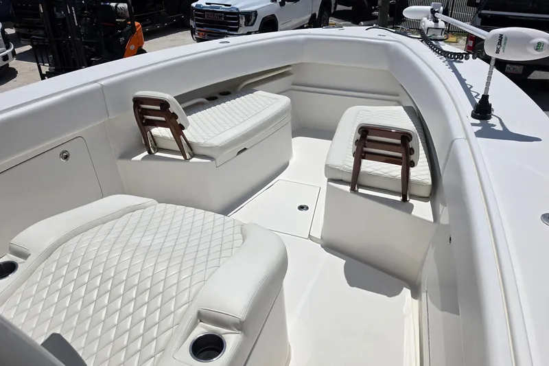 Slide: The Image of 2020 Jupiter 34 HFS boat interior with white quilted seating and cup holders. - 14